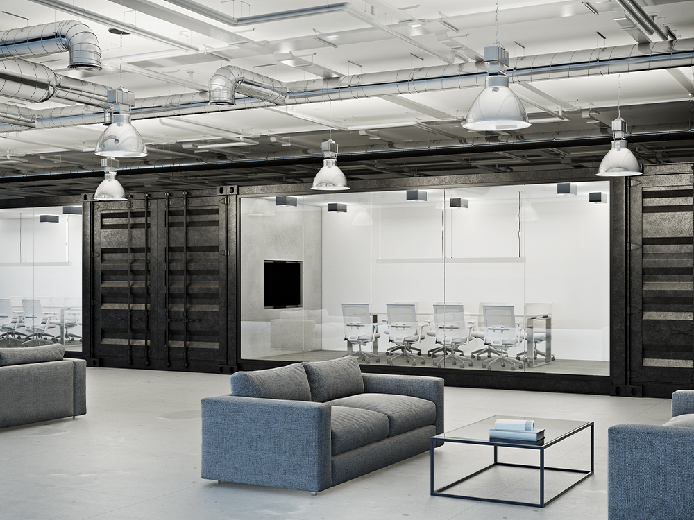 Una imagen renderizada en 3D de un moderno espacio de oficina con salas de juntas y áreas de descanso, construidas con contenedores marítimos de color oscuro.